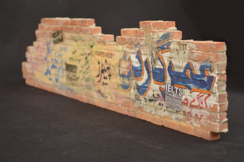 Noor Ali Chagani. The Wall 2, 2014. Terracotta bricks, cement and watercolour, 5 x 23.5 x 0.5 in (12.7 x 59.7 x 1.3 cm). Courtesy of the artist and White Turban Art Consultancy.